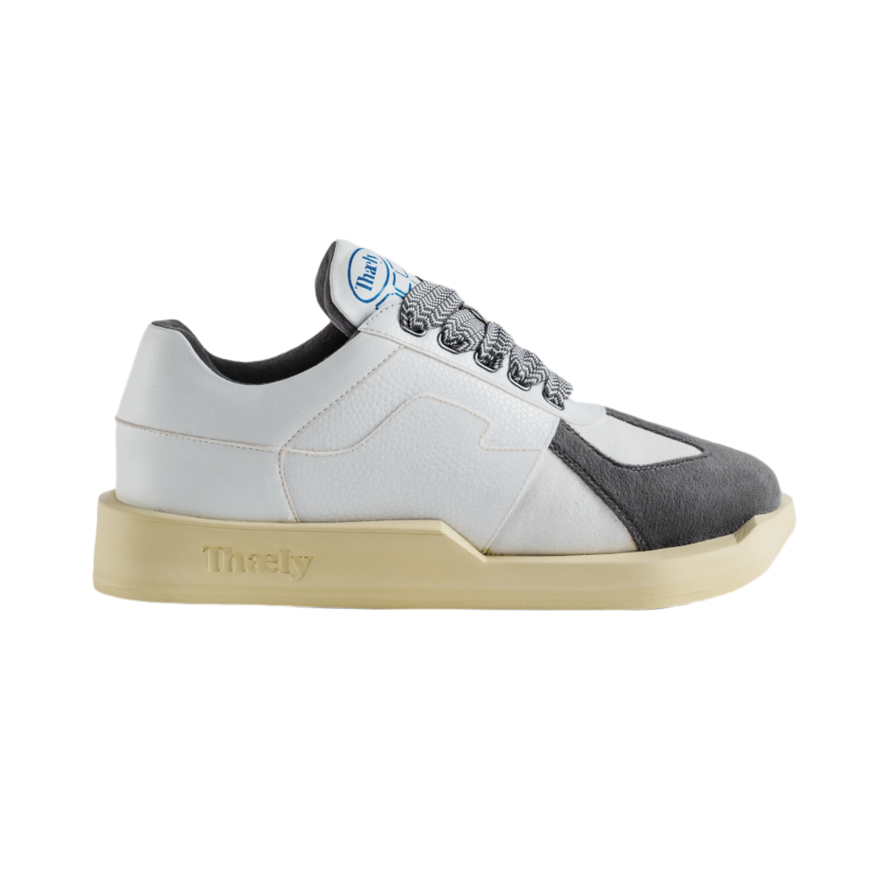 White and grey low-top streetwear sneaker with textured sole and patterned laces
