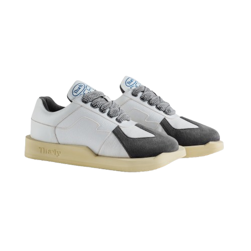 White and gray low-top streetwear sneakers with chunky beige sole and patterned laces