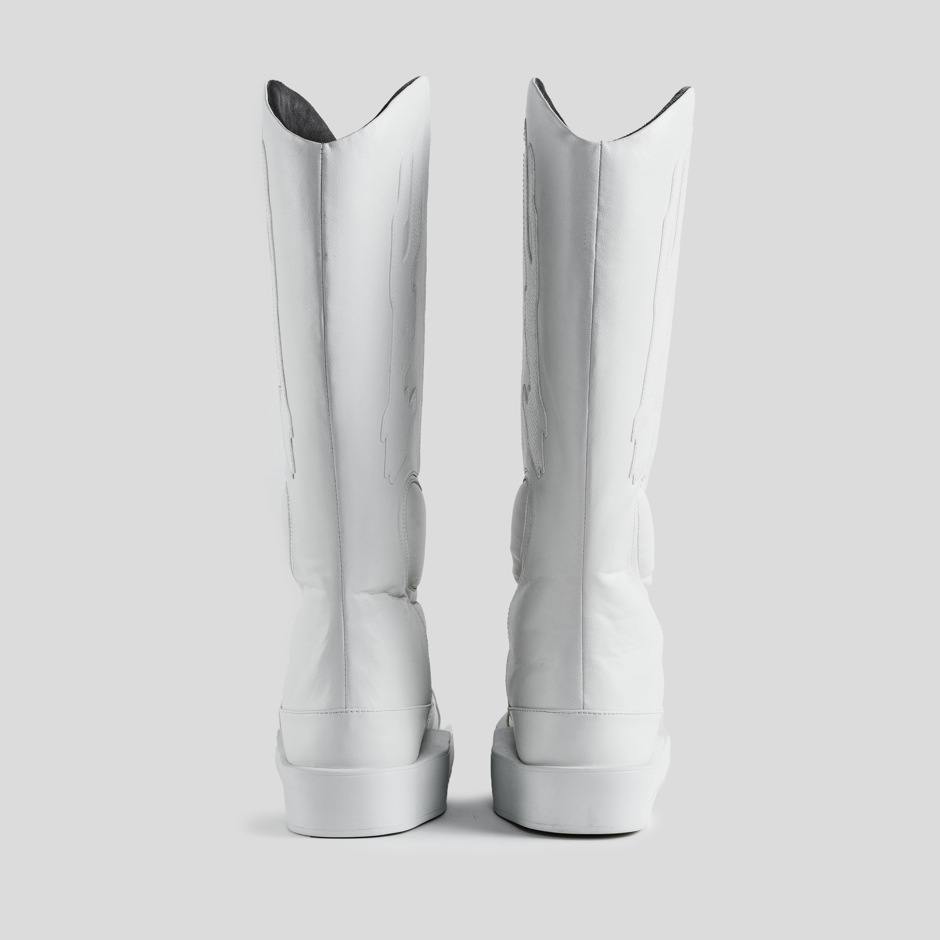 Back view of tall white leather boots on a light gray background, luxury footwear