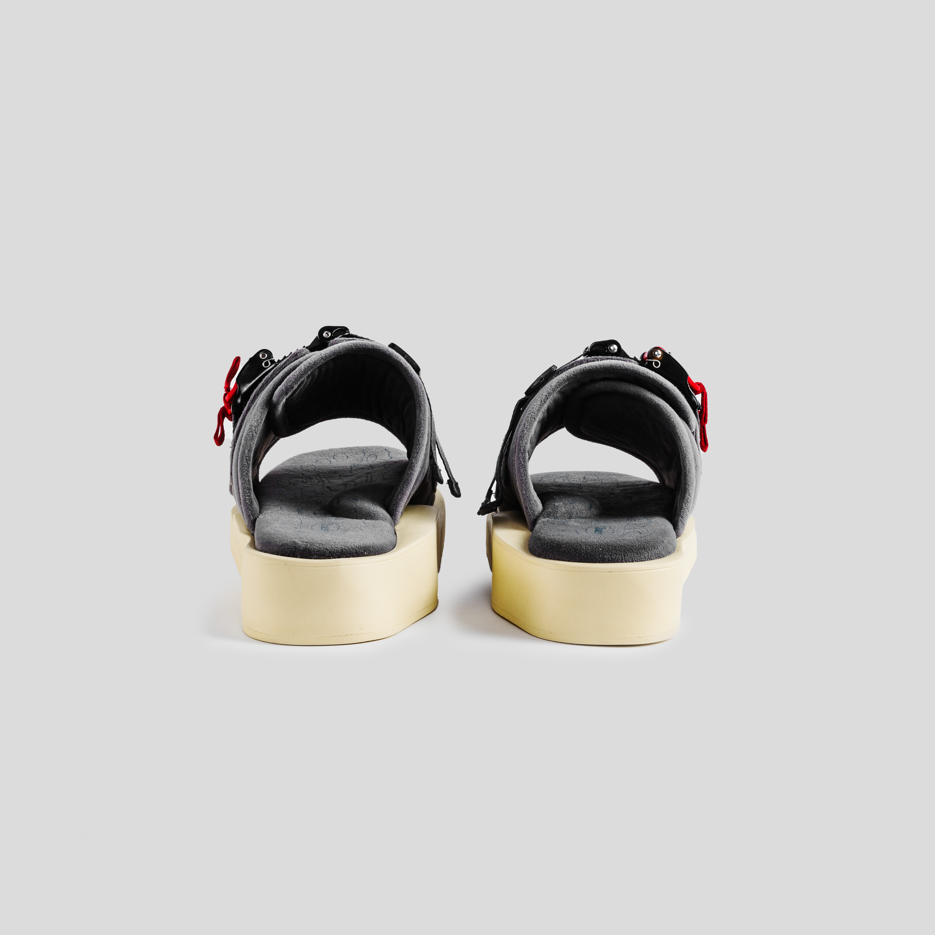 Back view of gray platform sandals with cushioned soles and adjustable straps