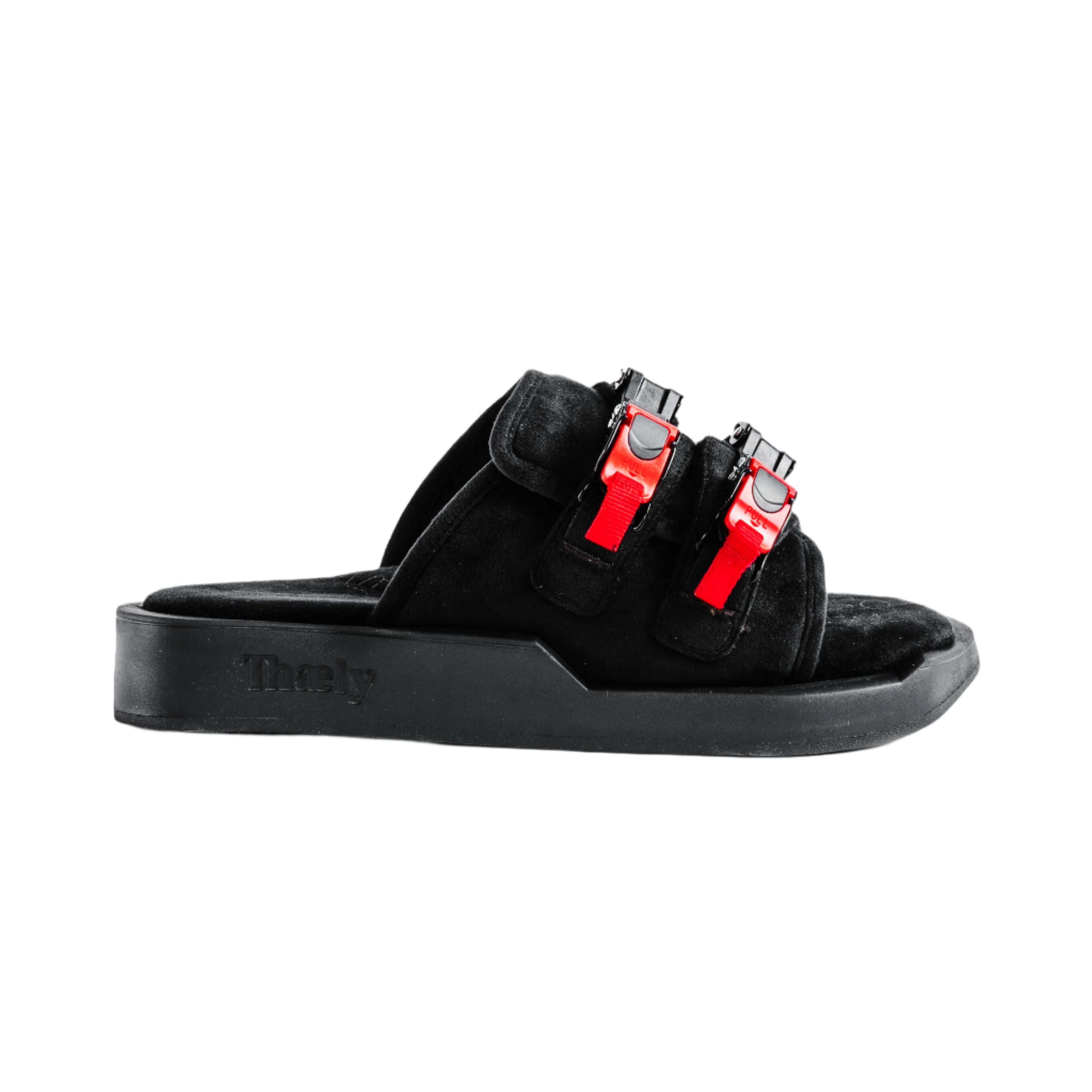 Black suede streetwear slide sandal with chunky sole and red buckle straps