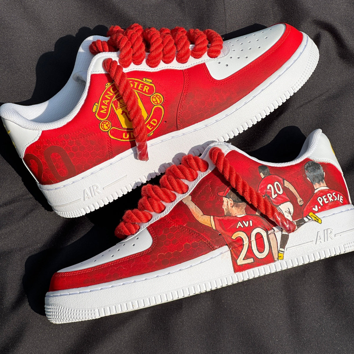 Custom red and white sneakers with Manchester United logo, player graphics, and thick red laces