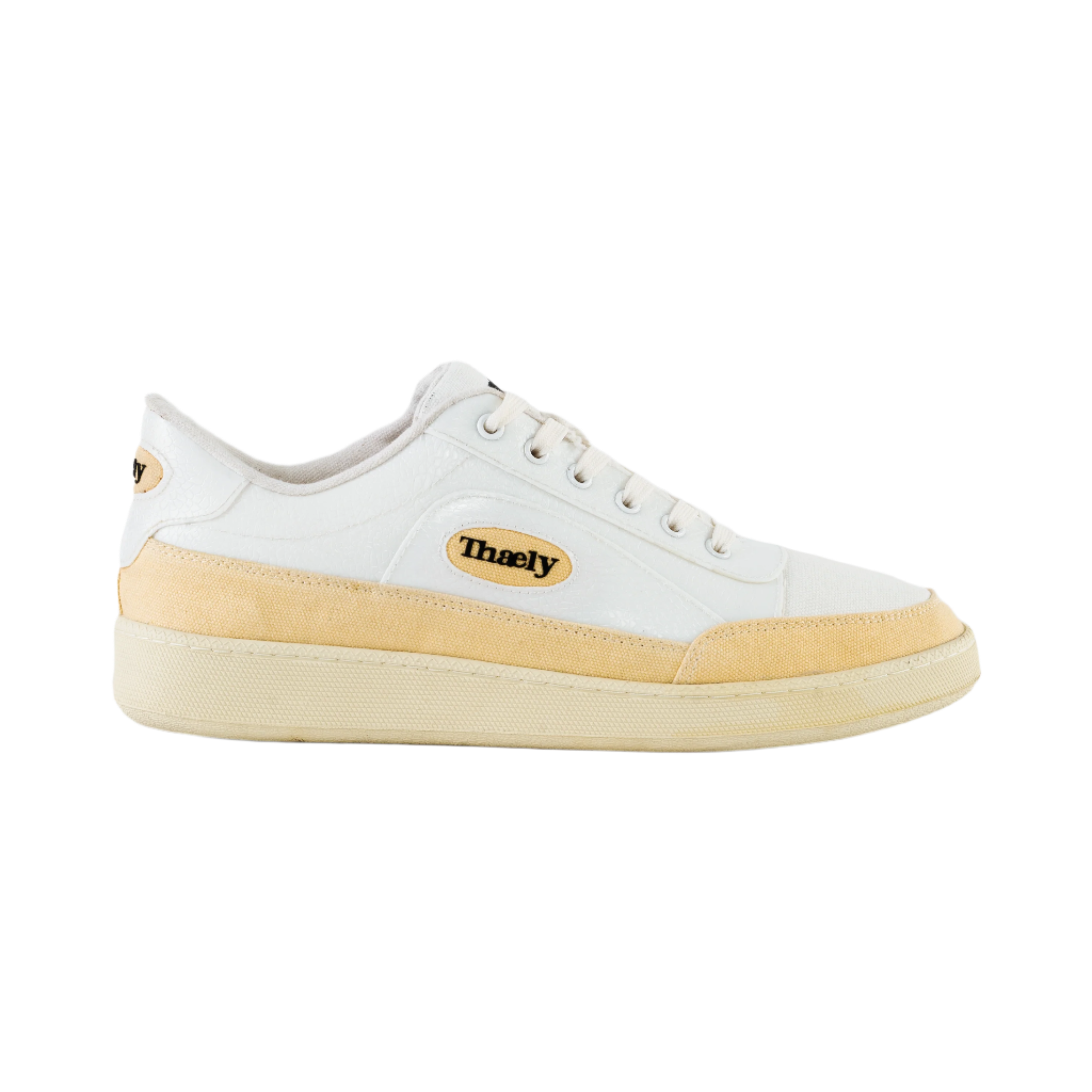 White and beige low-top streetwear sneaker with Thaely logo, minimalist design