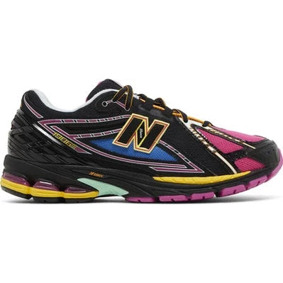 Black and pink New Balance sneaker with yellow accents, streetwear running shoe side view