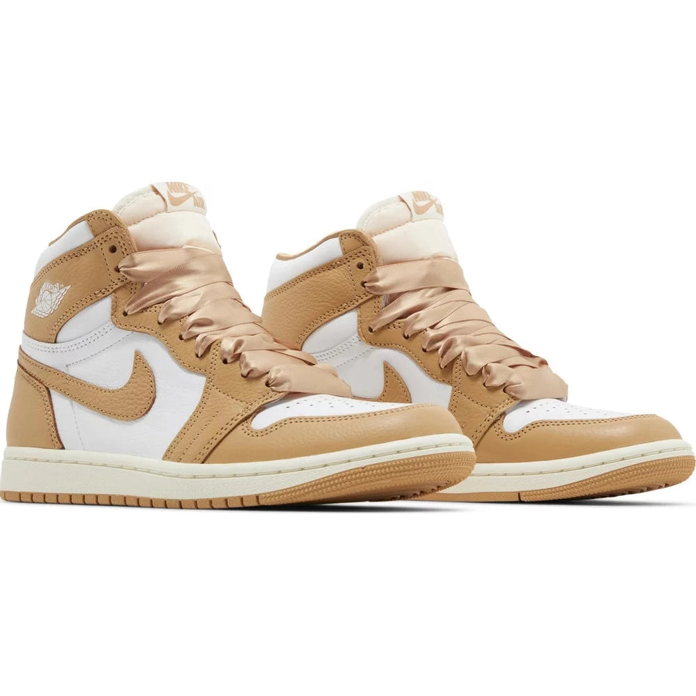 Tan and white high-top sneakers with satin laces, leather upper, side logo, and streetwear style.