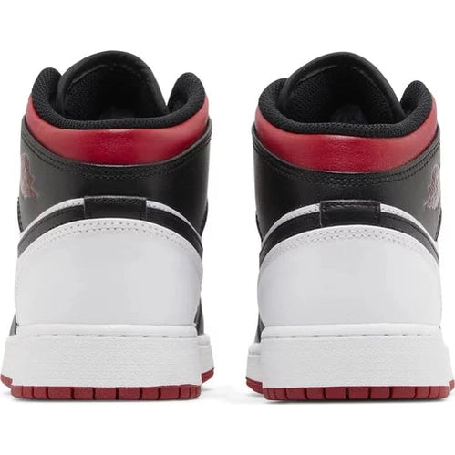 Back view of black, white, and red high-top sneakers on white background