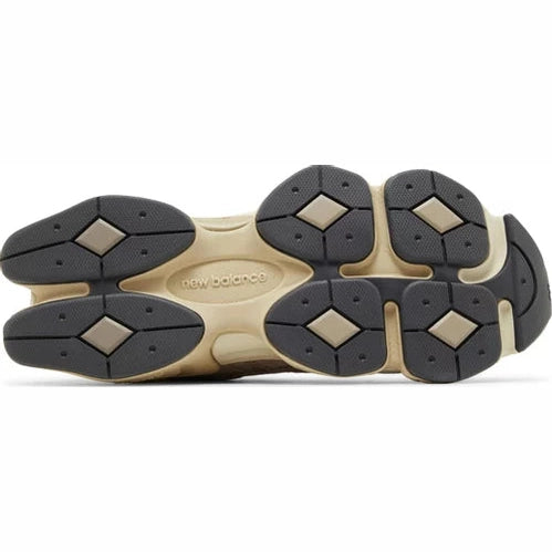 Close-up of New Balance sneaker outsole with black and beige tread pattern, luxury footwear