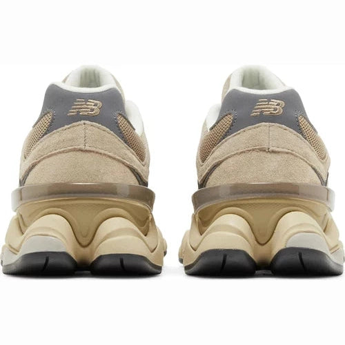 Rear view of beige and grey New Balance sneakers with chunky sole on white background