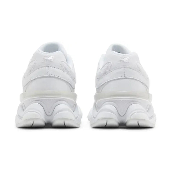 Back view of white New Balance sneakers with mesh and leather details on a white background
