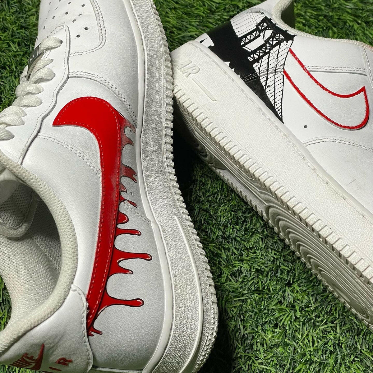 White streetwear sneakers with red custom swoosh designs on green grass