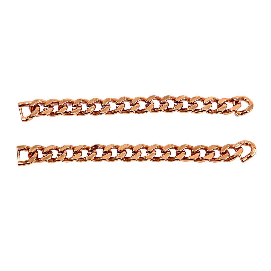 Two gold Cuban link sneaker chains laid out on a plain background.