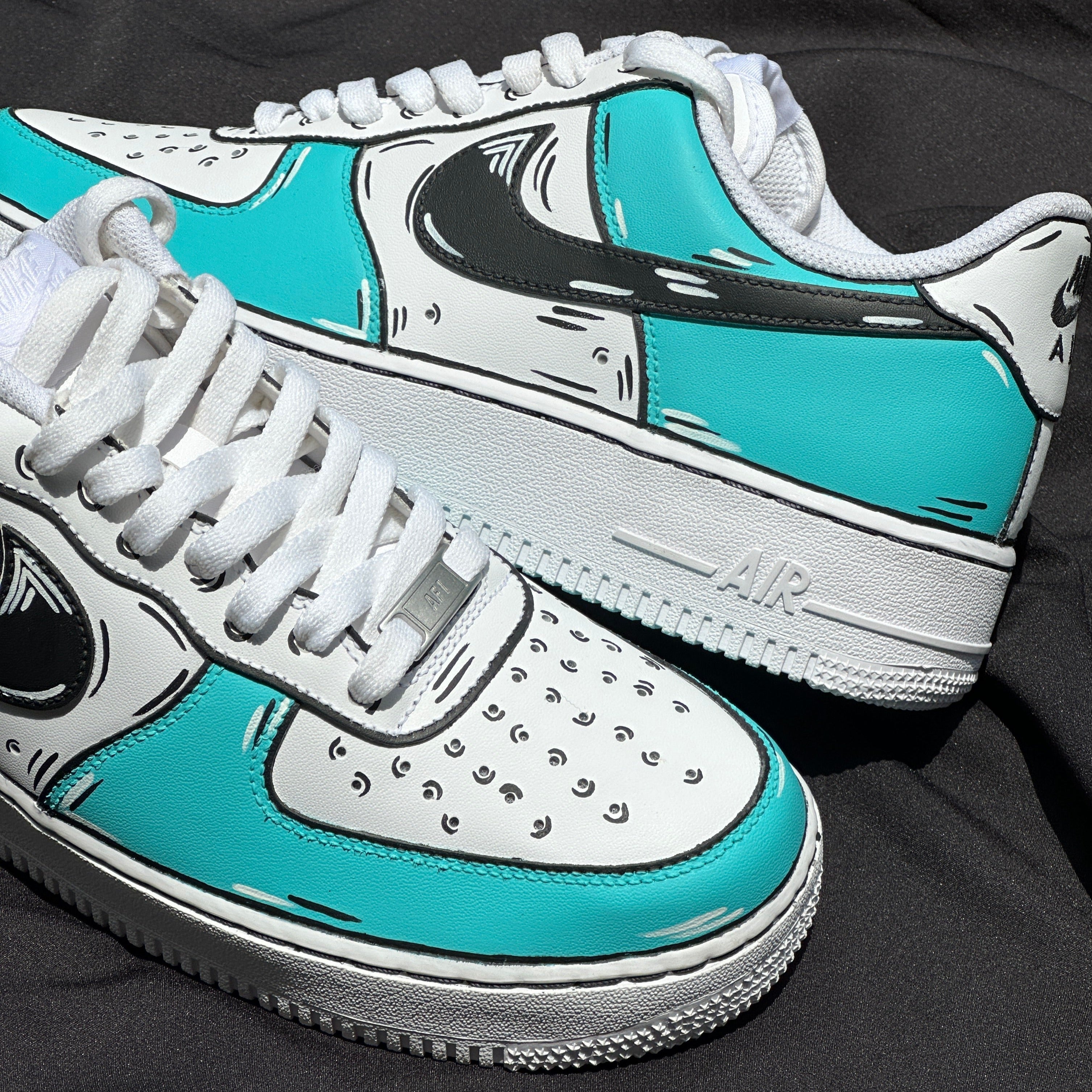Turquoise and white streetwear sneakers with cartoon effect, white laces, and black swoosh