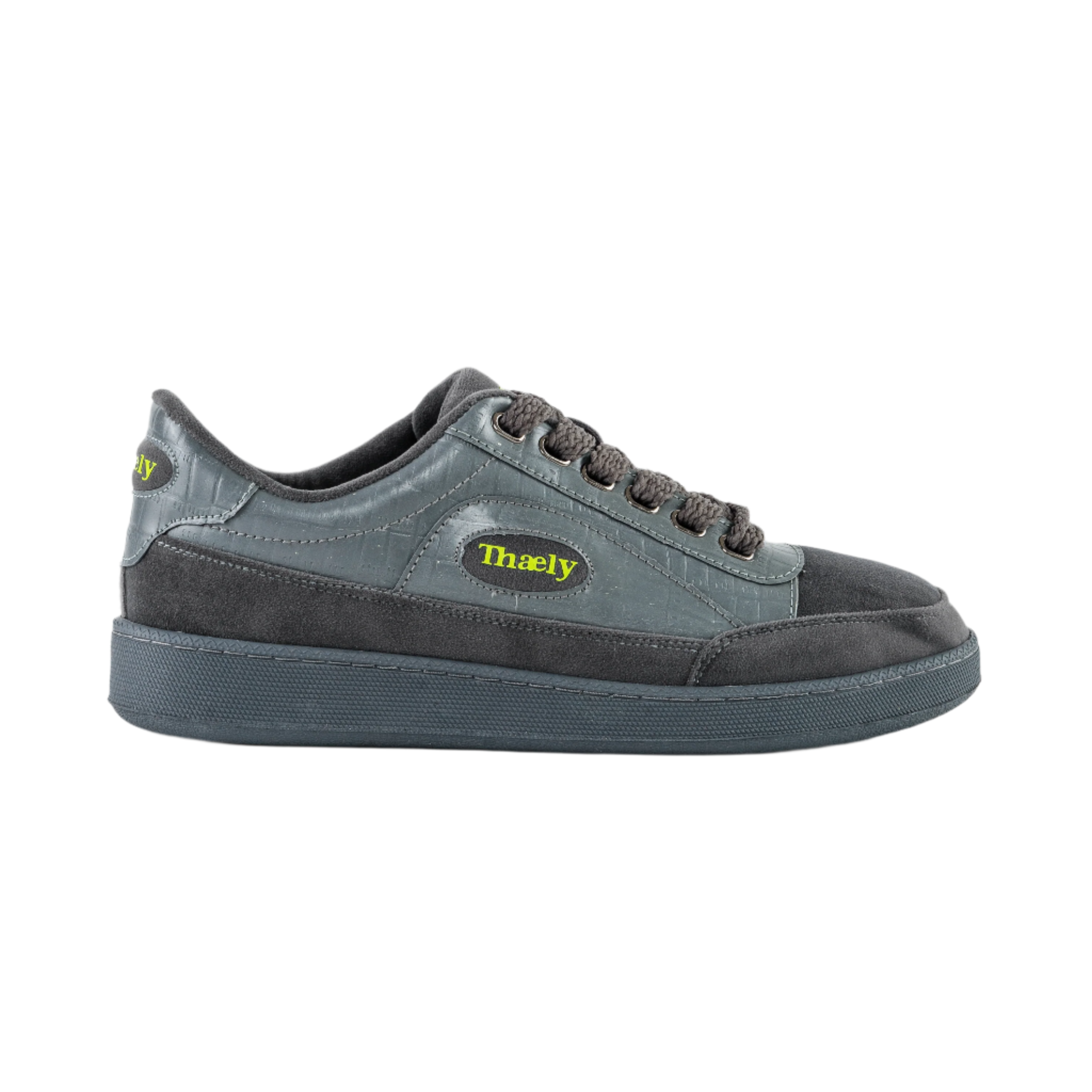Grey Thaely low-top streetwear sneaker with black sole and yellow logo on the side