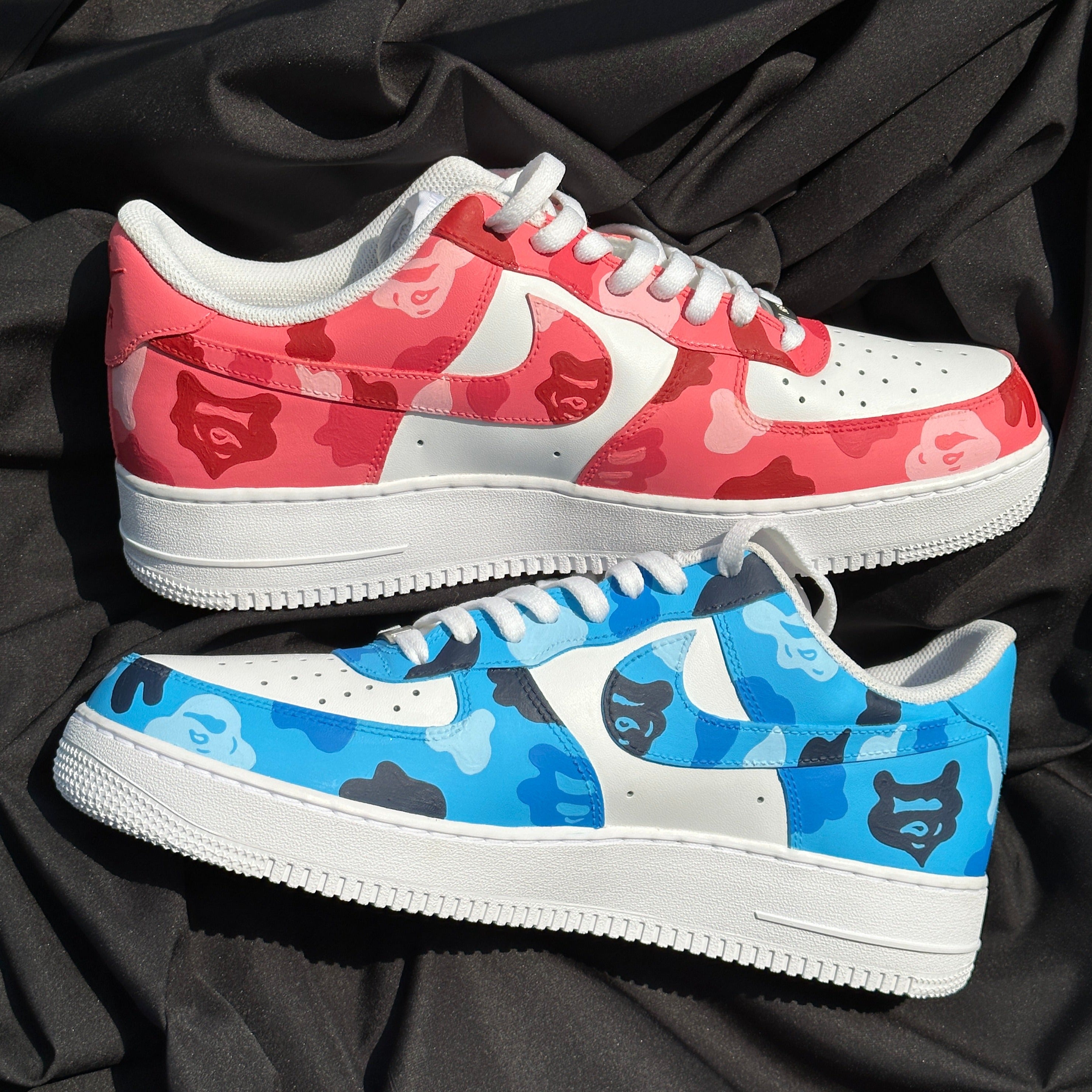 Red and blue camo sneakers with bear face patterns, white soles, streetwear style.