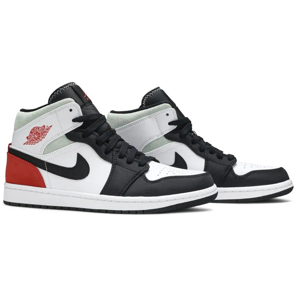 Black, white, red mid-top sneakers with visible suede overlays and classic basketball styling