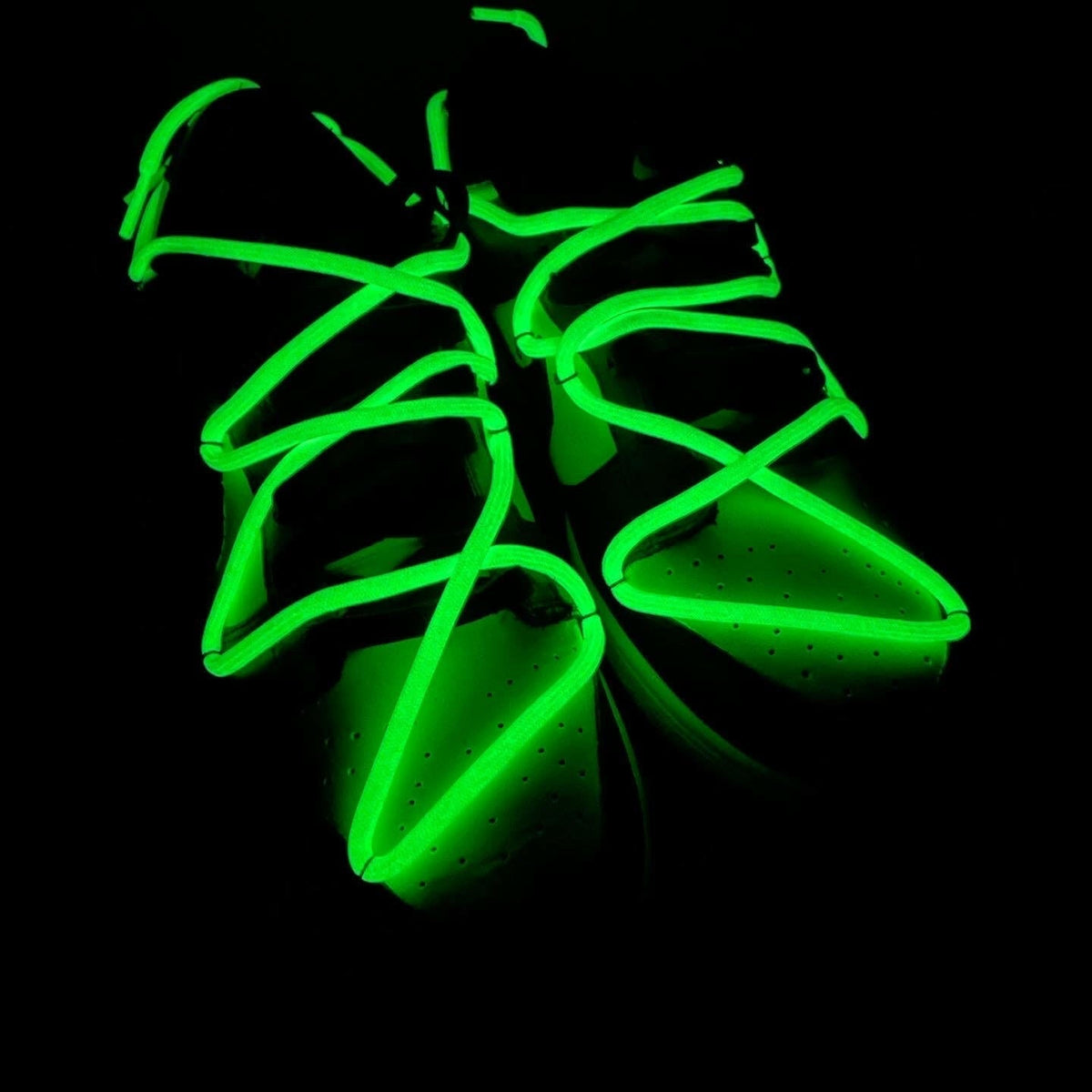 Glow in the dark sneaker laces on streetwear sneakers in low light