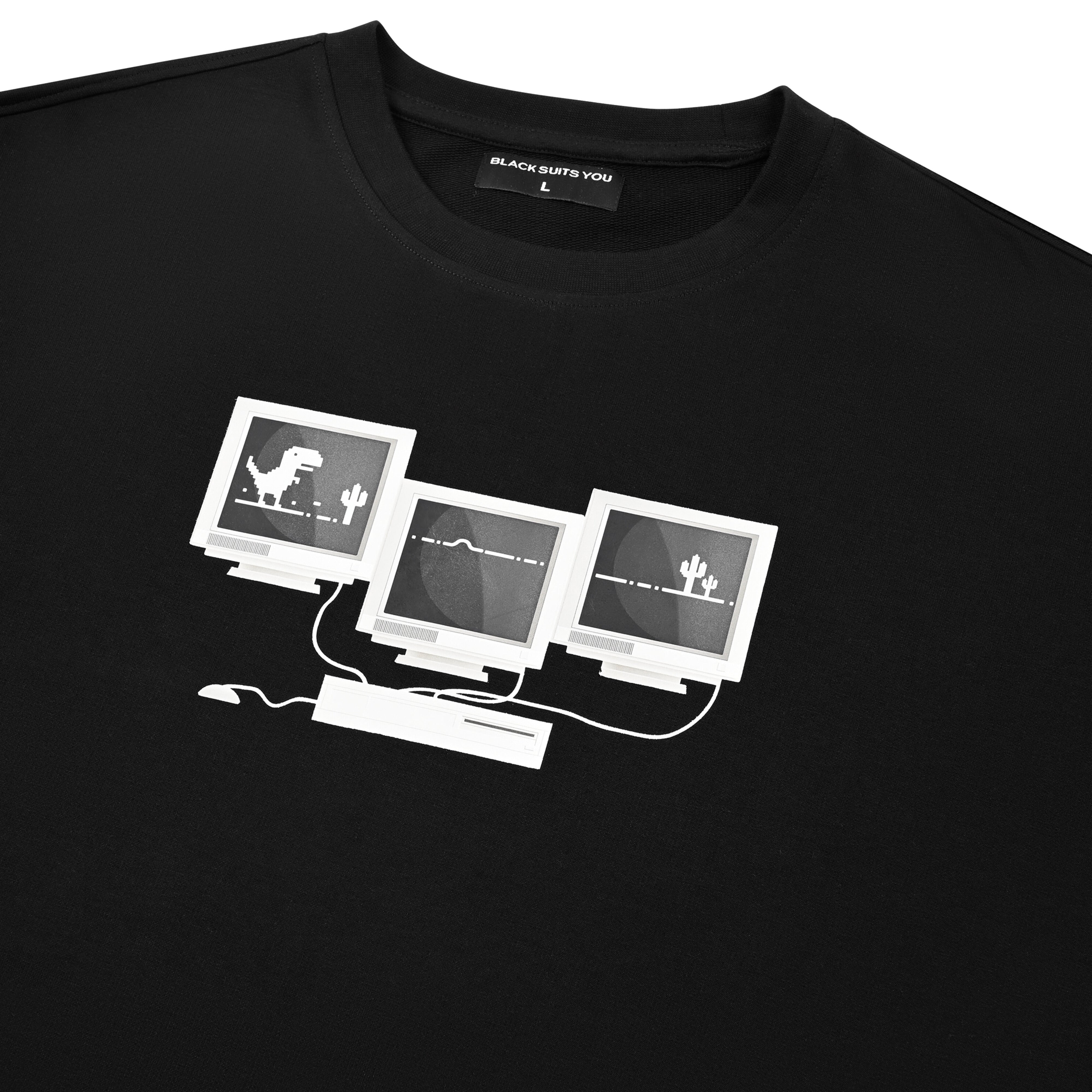 Black graphic t-shirt featuring retro computer monitors with pixel dinosaur and cacti design.