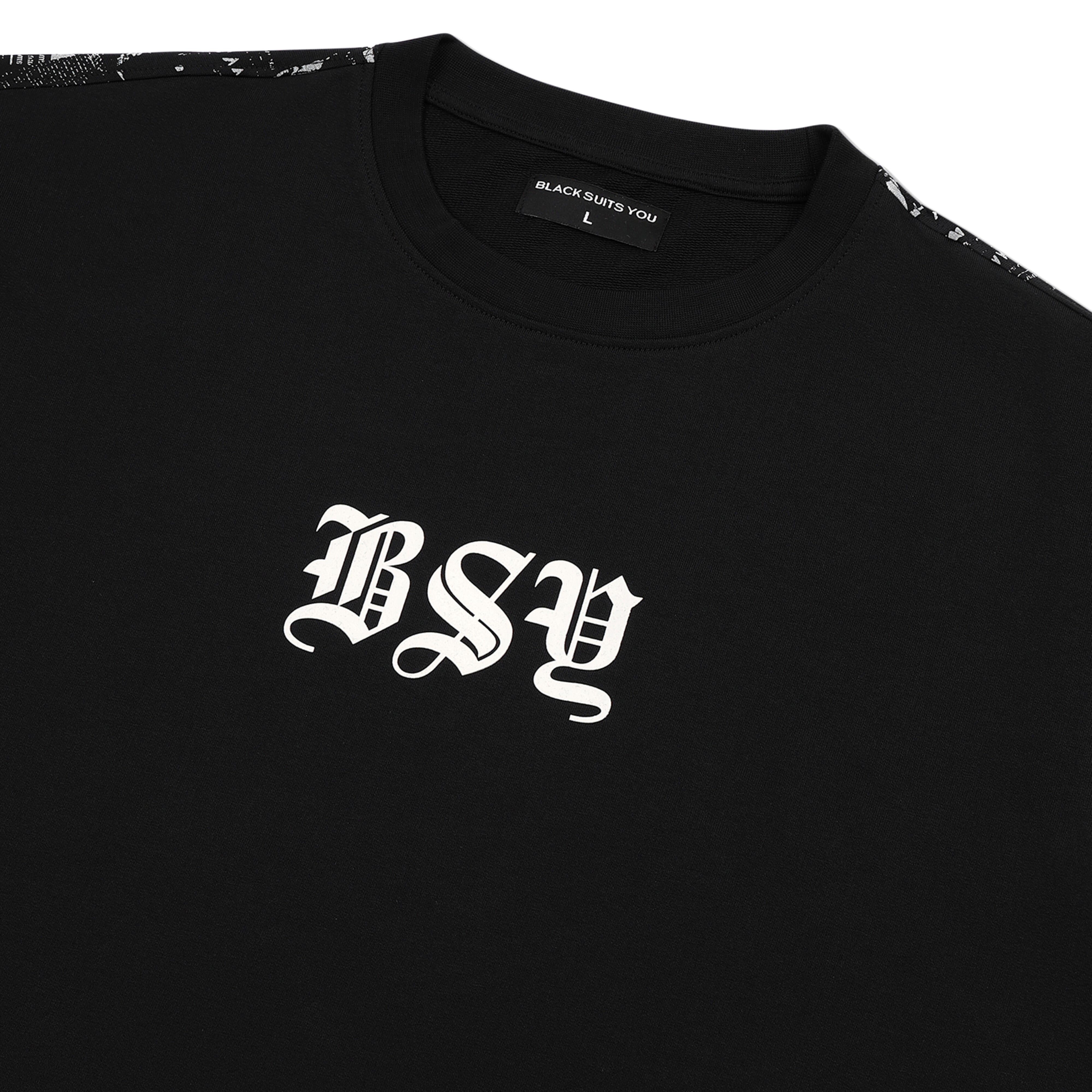 Black streetwear T-shirt with bold 'BSY' gothic lettering on chest and patterned shoulder detail