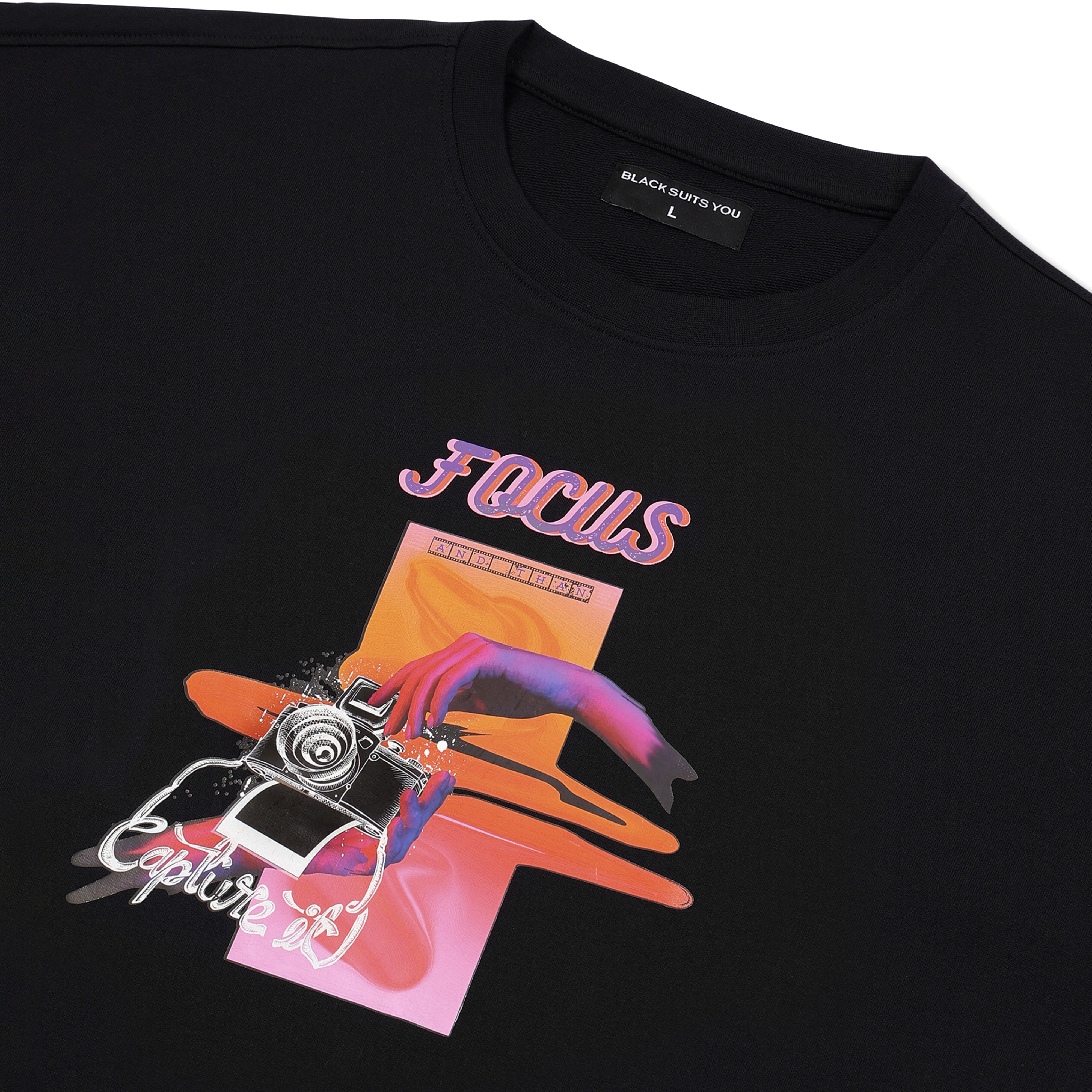 Black streetwear t-shirt with colorful graphic of a camera, hand, and 'Focus' text.