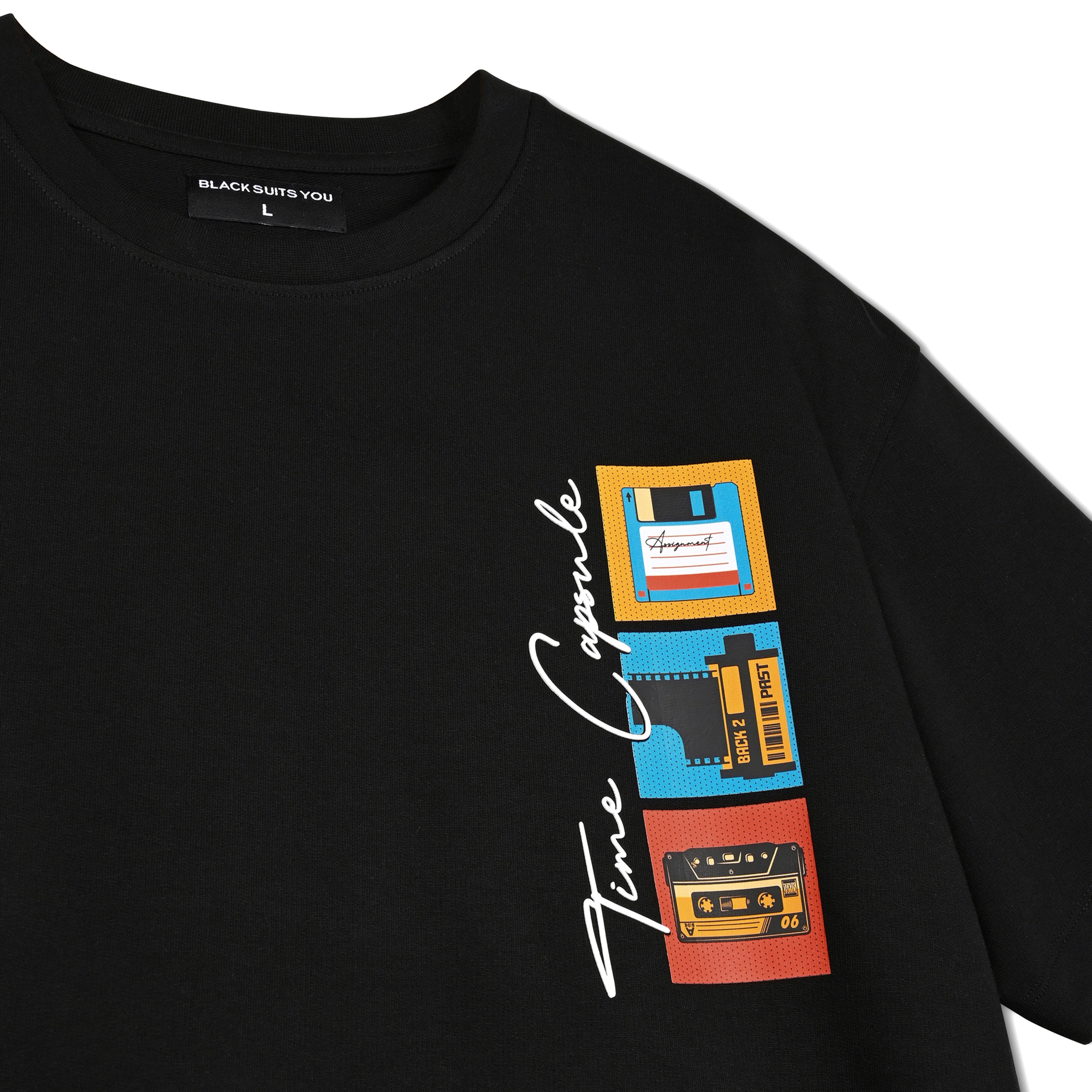 Black streetwear T-shirt with retro graphics of floppy disk, film roll, and cassette, time capsule design