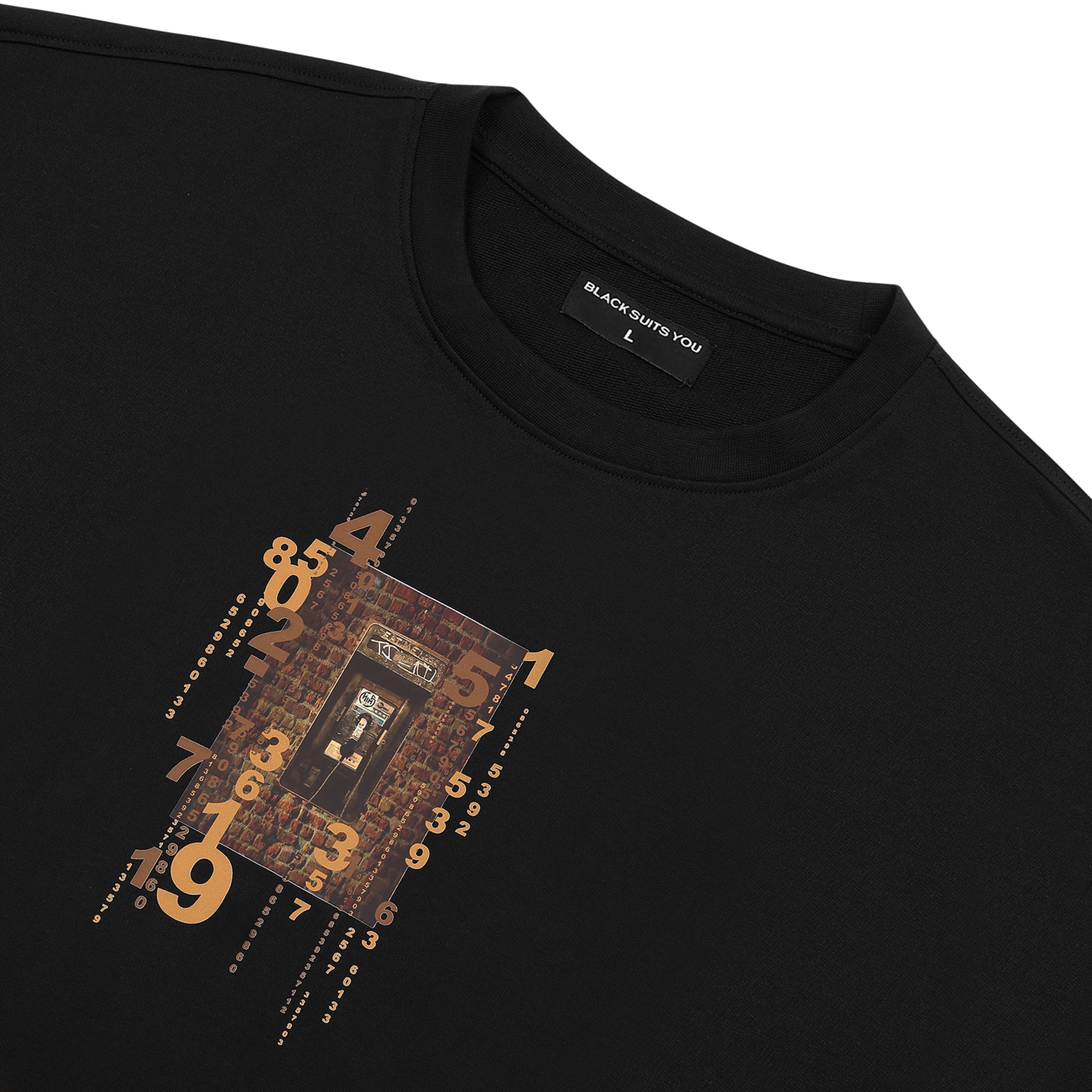 Black streetwear t-shirt with abstract numbers and brown graphic center print, flat lay view