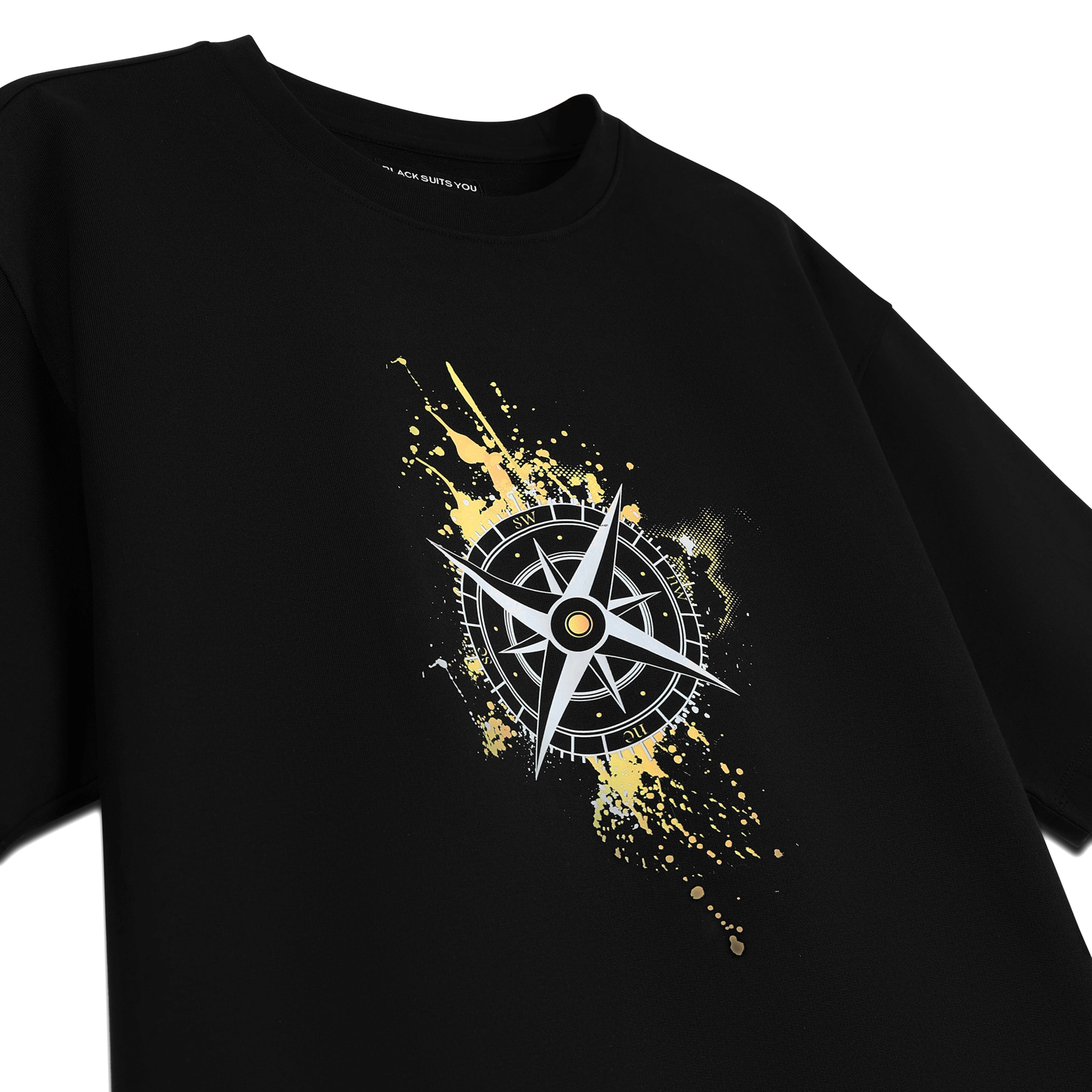 Black streetwear t-shirt with yellow paint splatter and compass print graphic on front