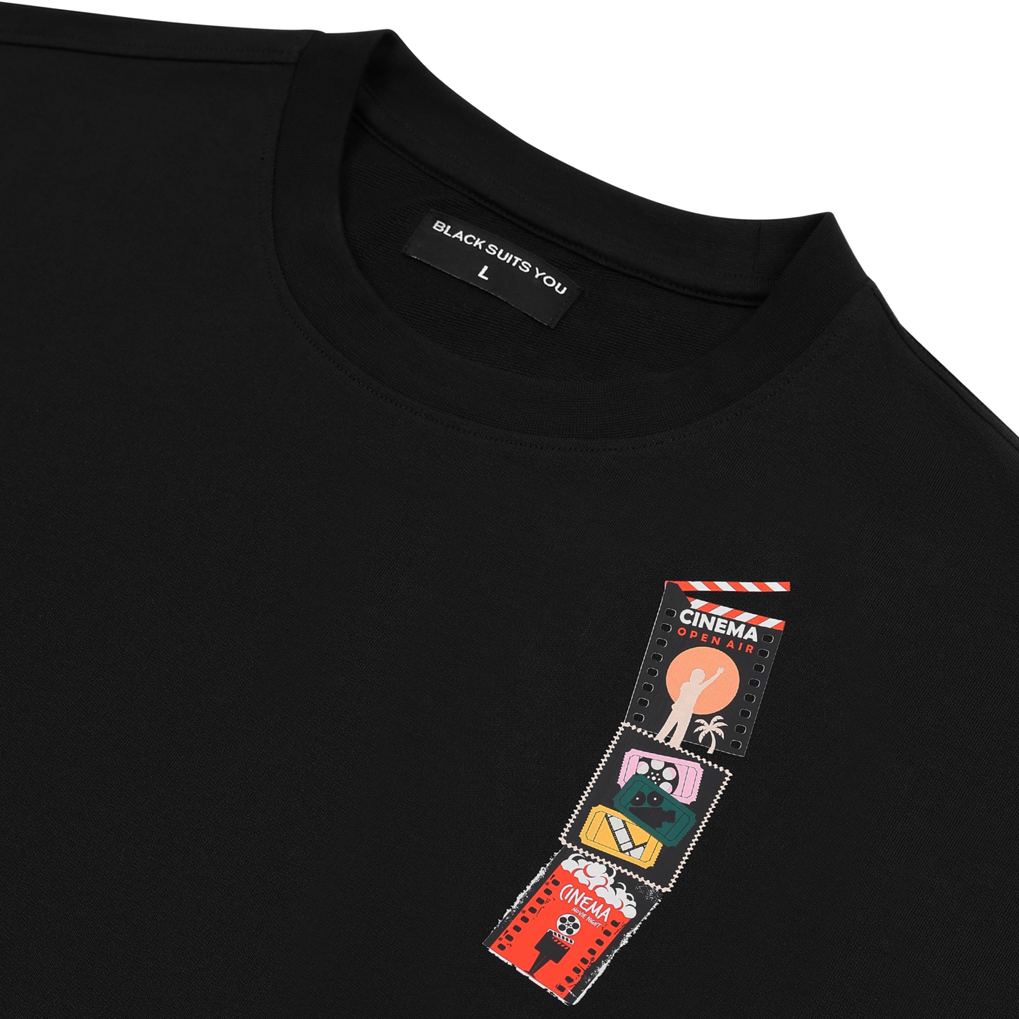 Black streetwear t-shirt with cinema-themed graphic patches and crew neck.