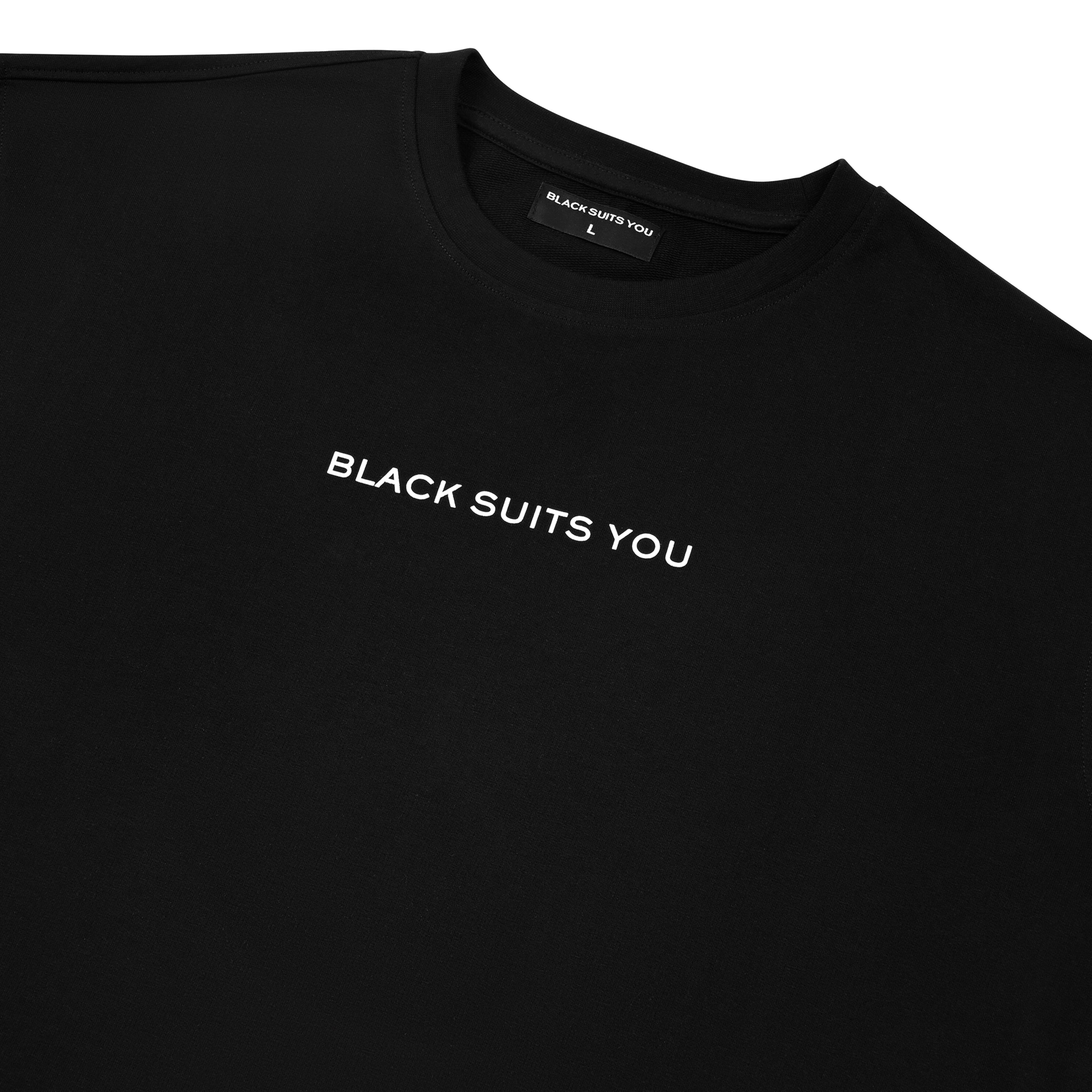 Black streetwear t-shirt with 'BLACK SUITS YOU' white text on chest, laid flat