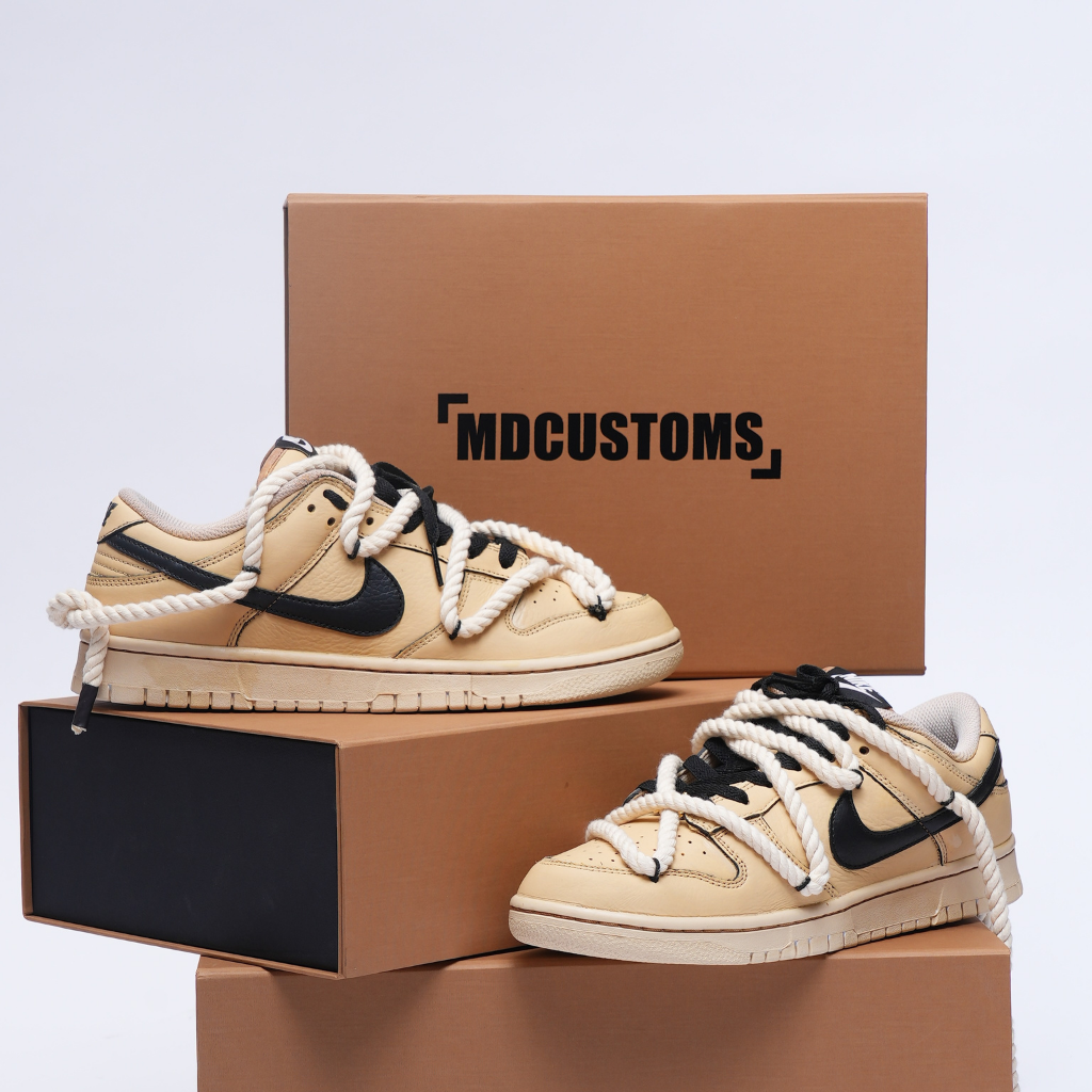 Beige and black custom low-top sneakers with rope laces, displayed on brown shoe boxes