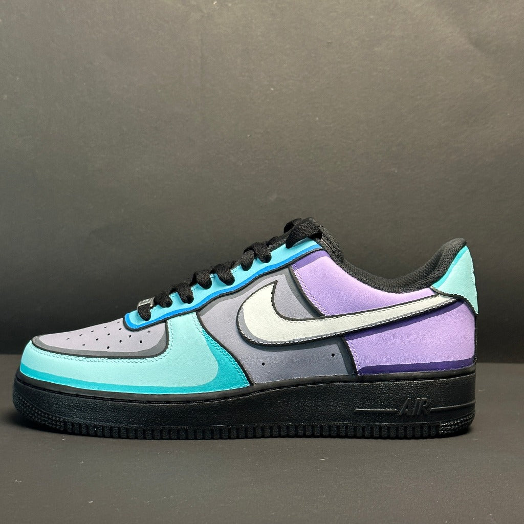 Colorful streetwear sneaker with blue, purple, and gray color blocks on a black sole