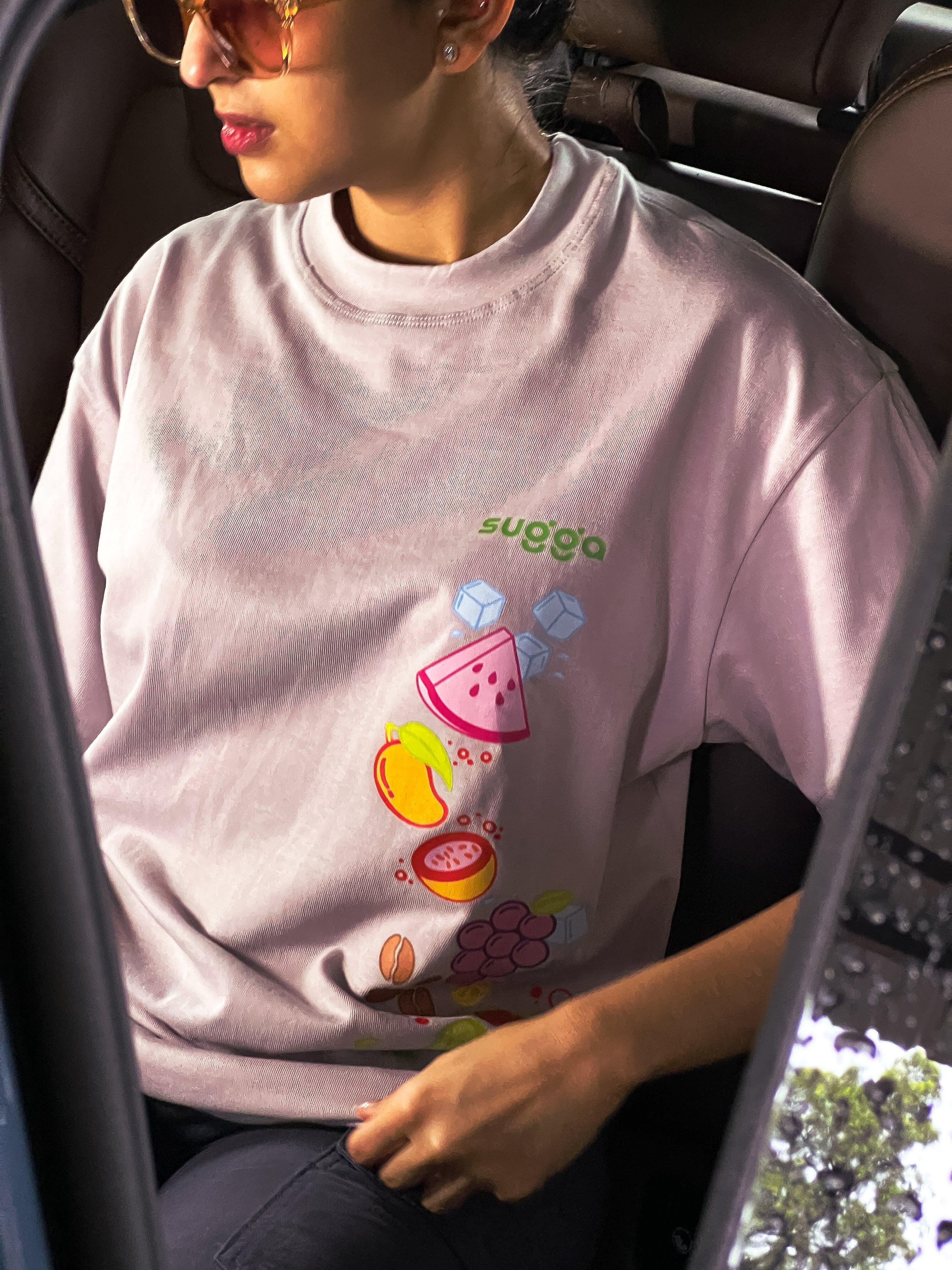 Woman in sunglasses wearing pastel streetwear t-shirt with colorful fruit graphic print