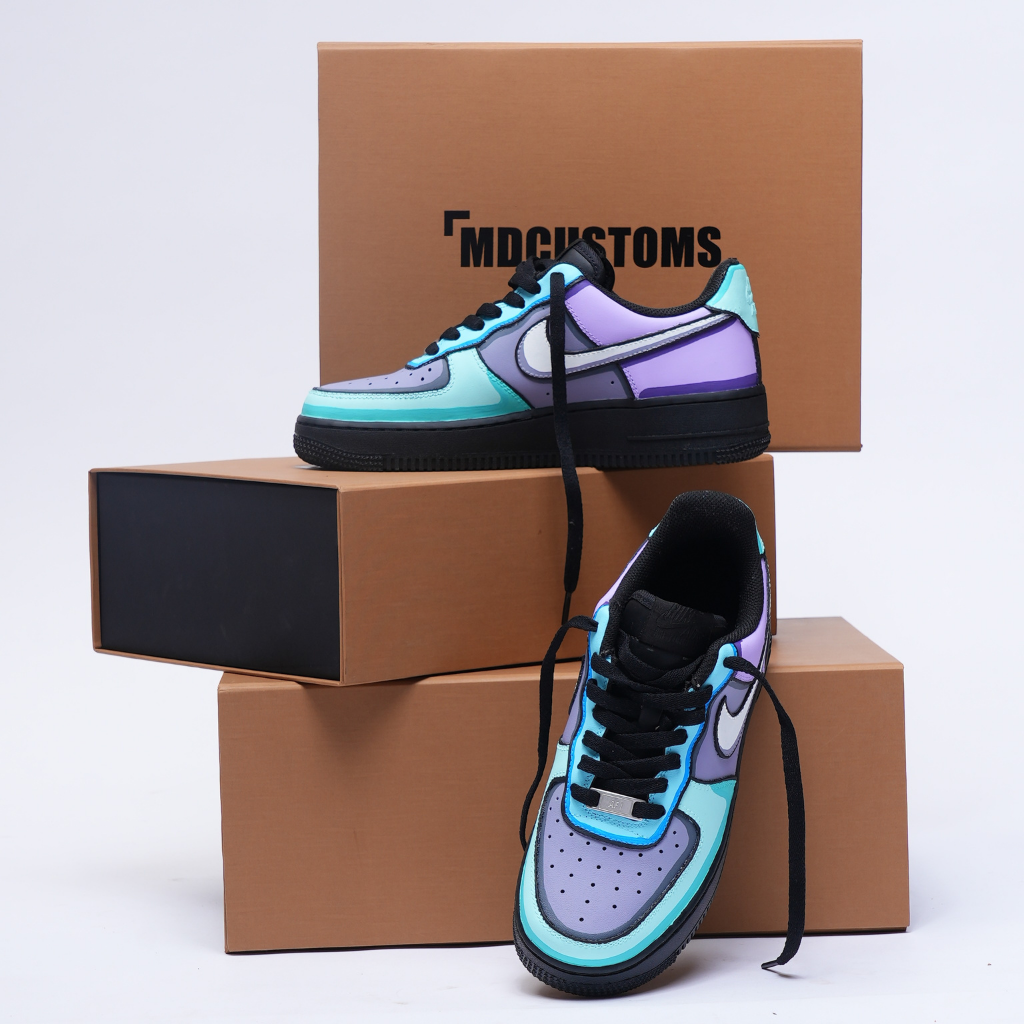 Custom pastel blue and lavender streetwear sneakers displayed on stacked shoe boxes