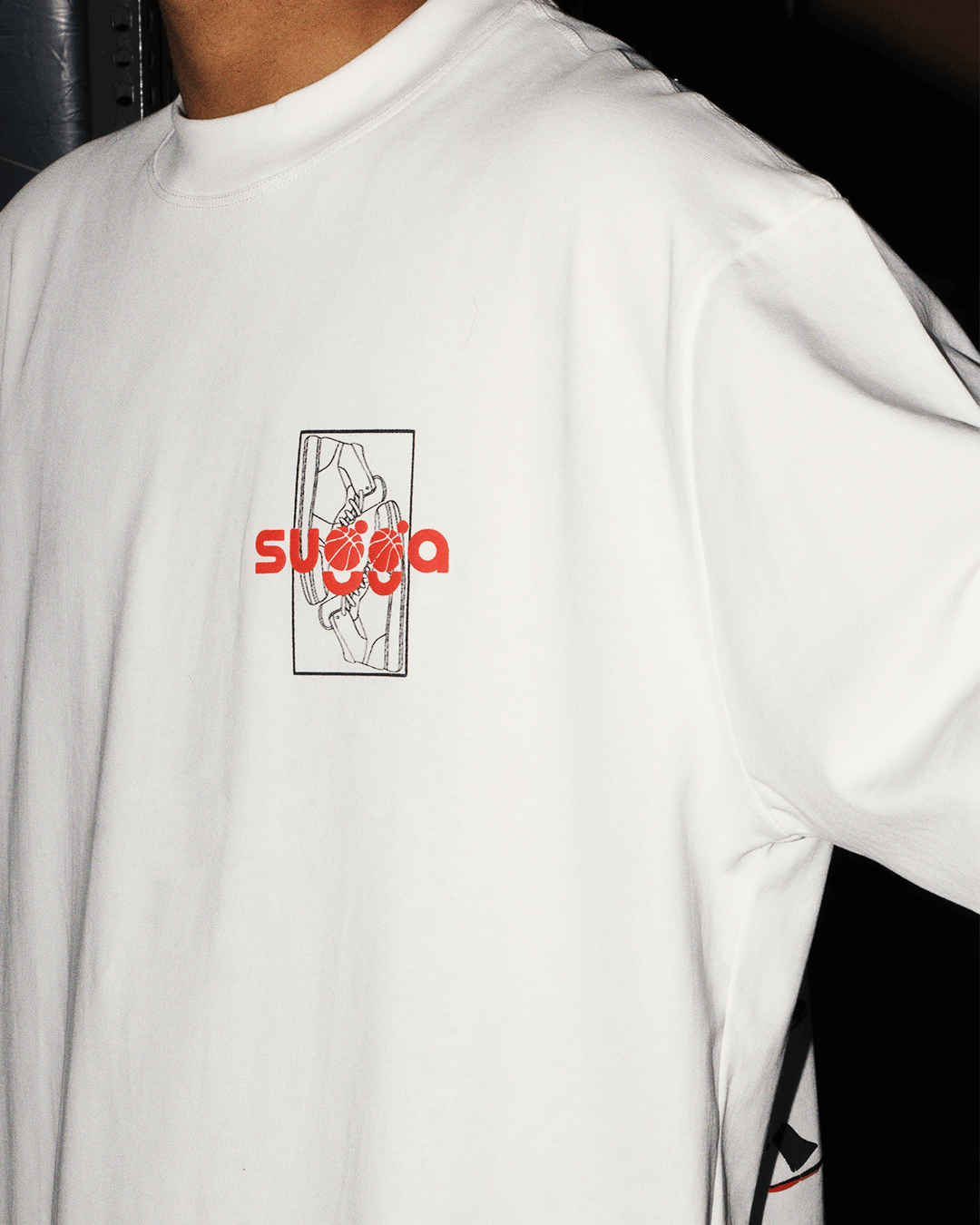 White streetwear t-shirt with red graphic text and sneaker outline design on chest