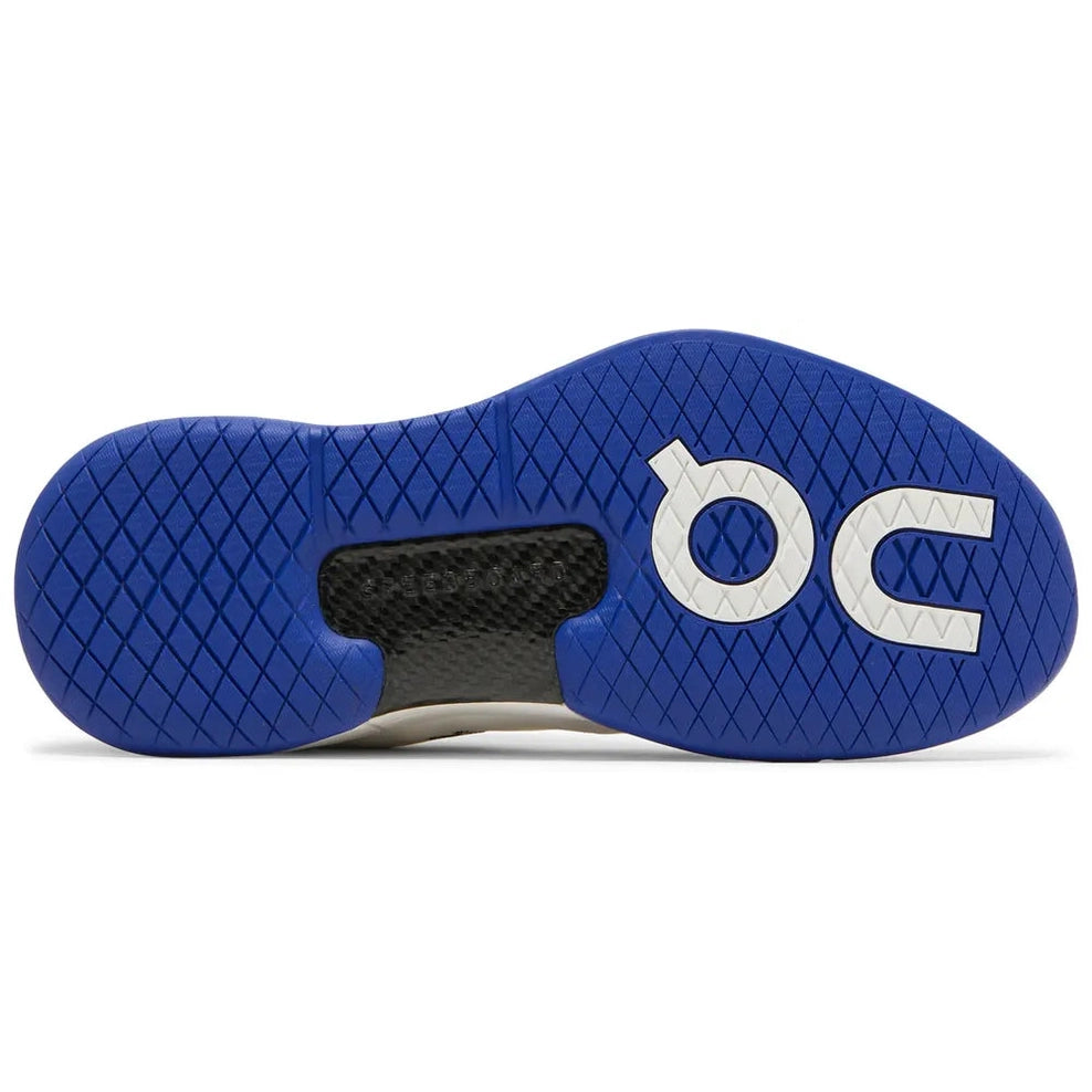 Blue rubber sneaker sole with diamond tread pattern and white lettered branding, streetwear shoe