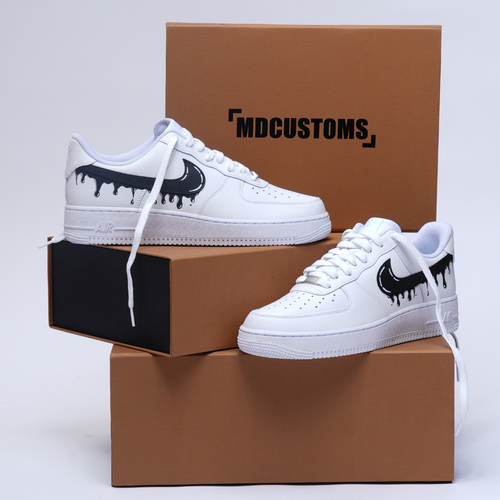 White custom streetwear sneakers with black drip Swoosh design, displayed on shoeboxes