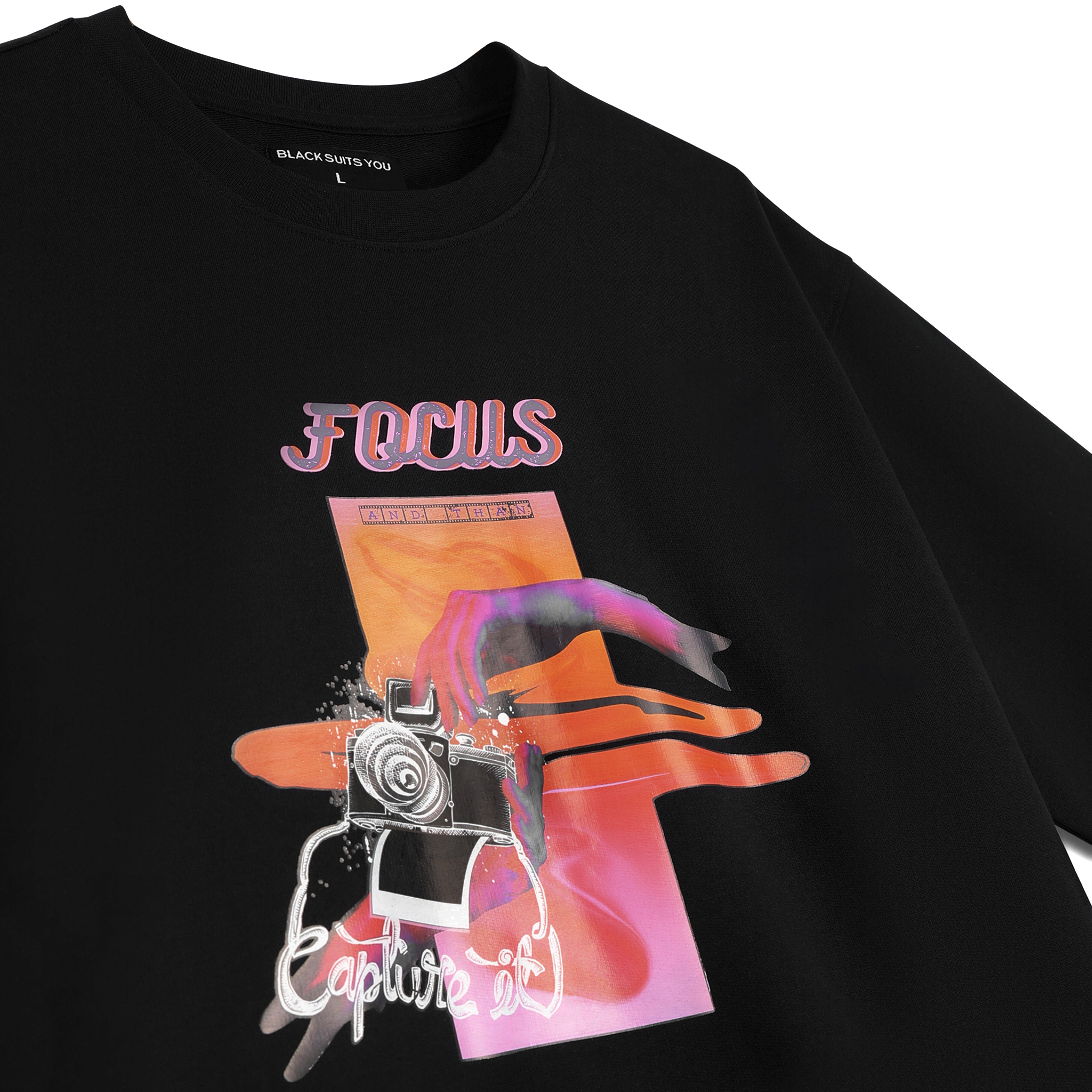 Black graphic streetwear t-shirt with FOCUS and Capture It text, camera and colorful hand design