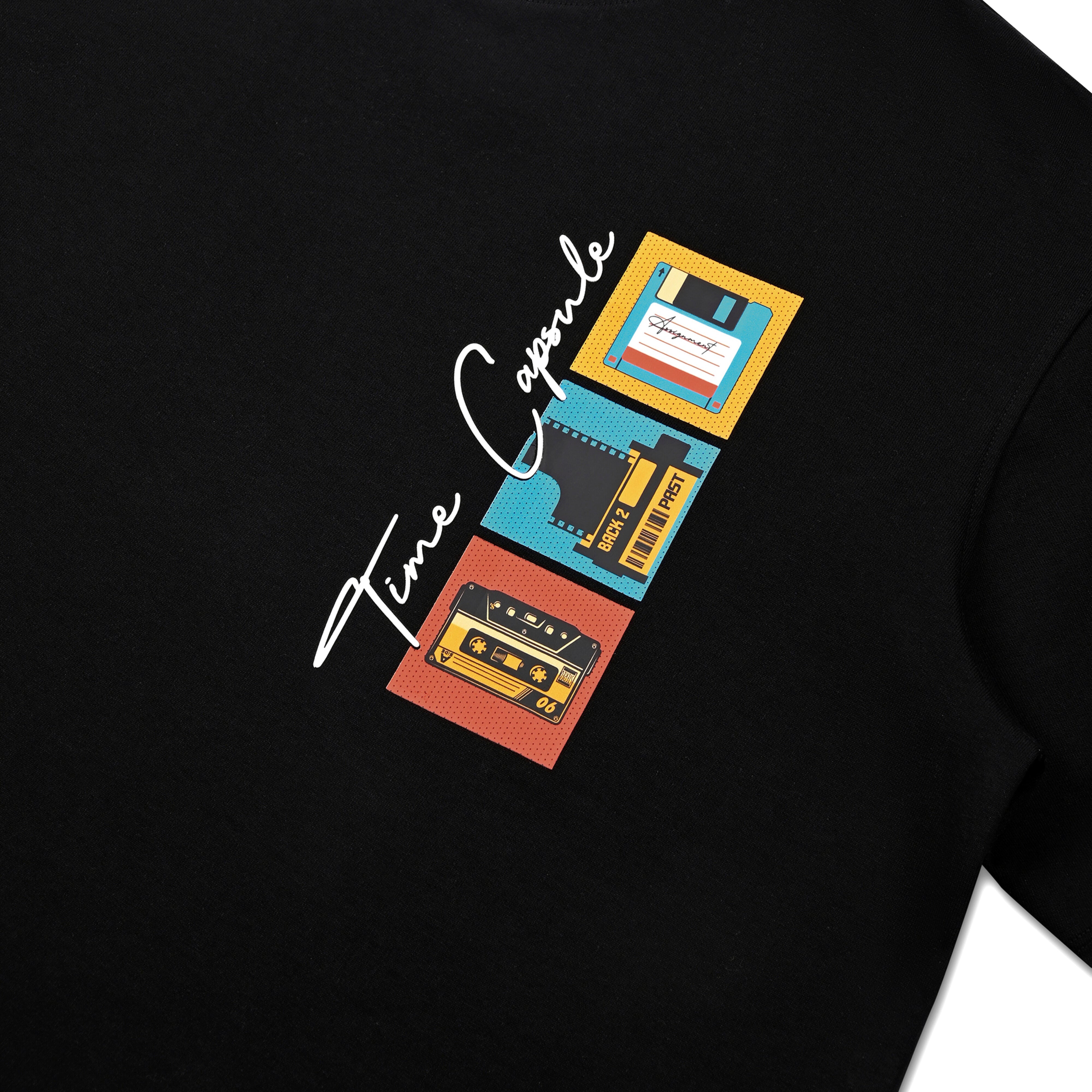 Black streetwear t-shirt featuring retro cassette, floppy disk, film graphic and 'Time Capsule' text.