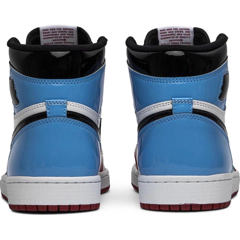 Back view of blue, white, and black high-top sneakers with red soles