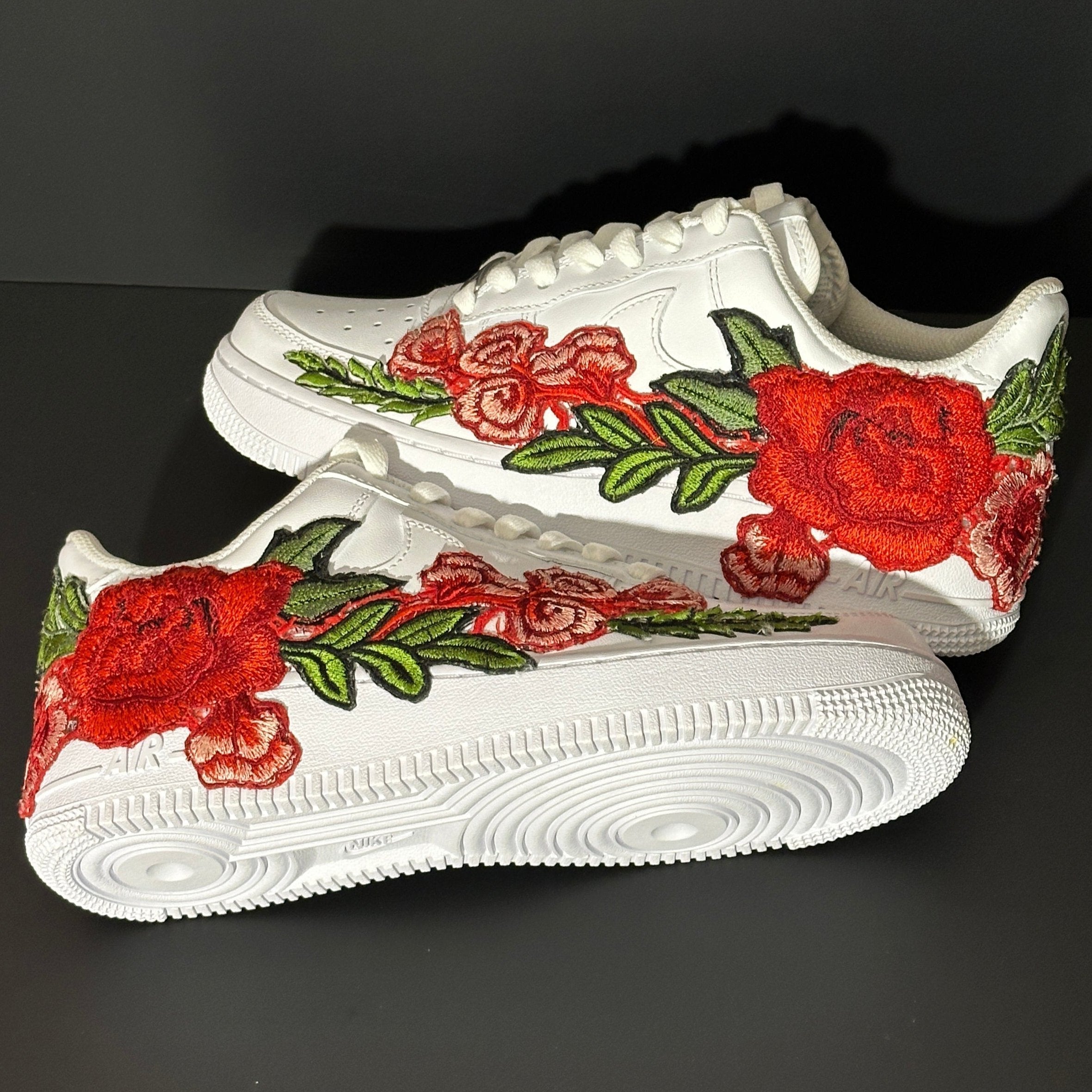 White sneakers with red rose floral embroidery, streetwear designer shoes on black background