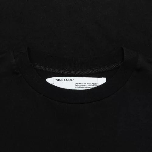 Black streetwear t-shirt close-up with white neck label and round neckline