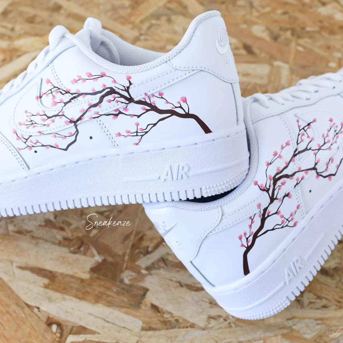 White sneakers with cherry blossom branch design, streetwear fashion footwear.
