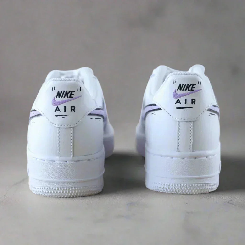 Back view of white Nike Air Force 1 sneakers with purple swoosh on neutral background