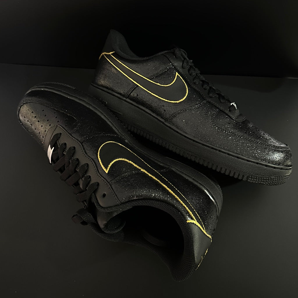 Black leather streetwear sneakers with yellow-outlined swoosh, designer footwear