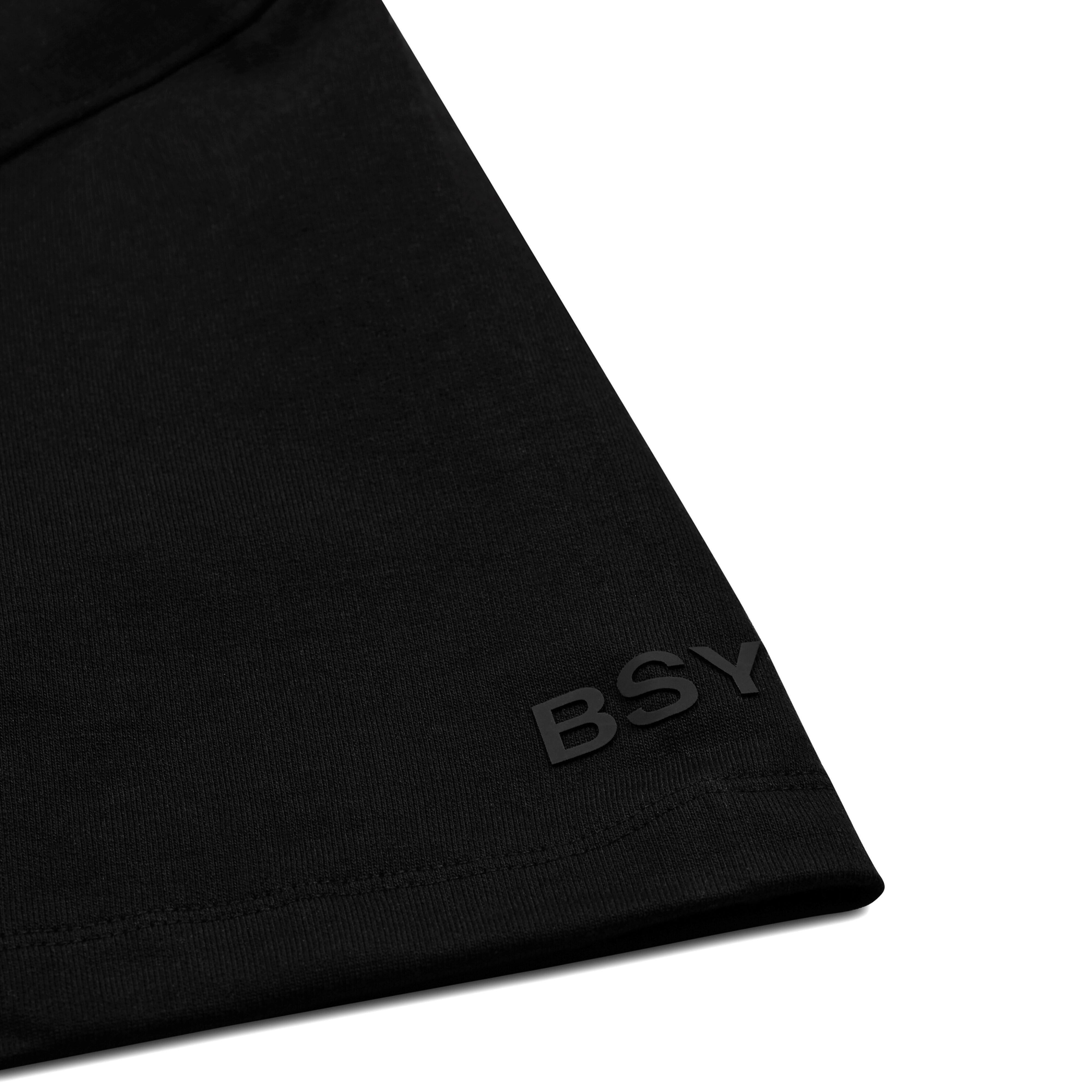 Black streetwear t-shirt sleeve with embossed BSY letters, closeup detail shot