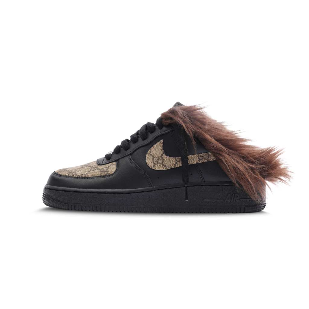 Black designer sneaker with brown furry detailing and monogram pattern on side and toe.