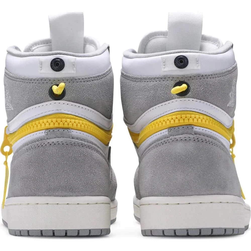 Rear view of grey and white high-top sneakers with yellow zipper detail and suede finish
