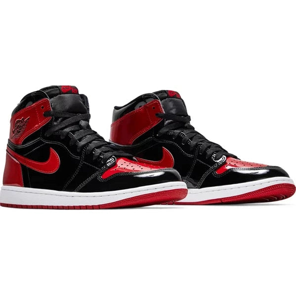 Black and red high-top sneakers with patent leather, white midsoles, and red outsoles.