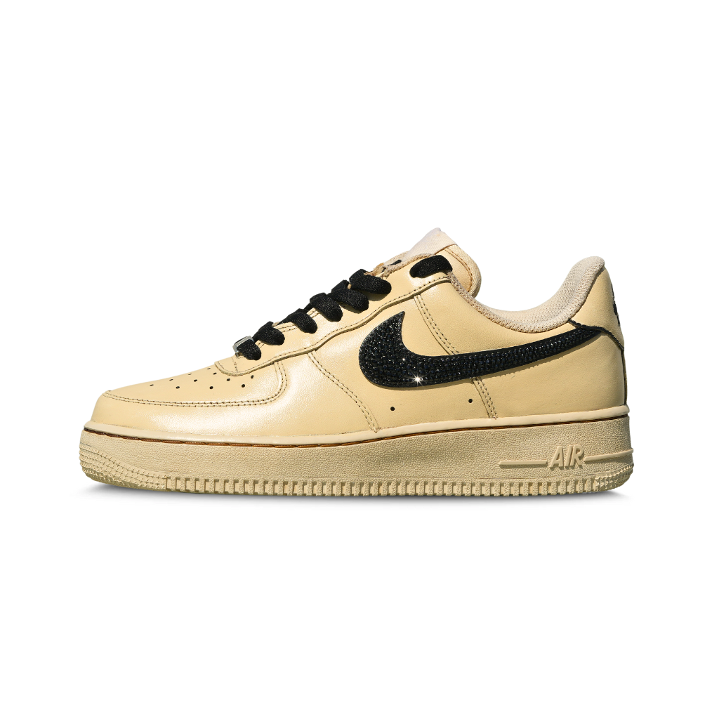 Beige leather low-top sneaker with black laces and black textured Swoosh, side view