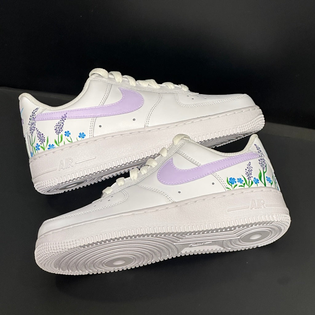 White sneakers with light purple swoosh and floral design, streetwear style footwear