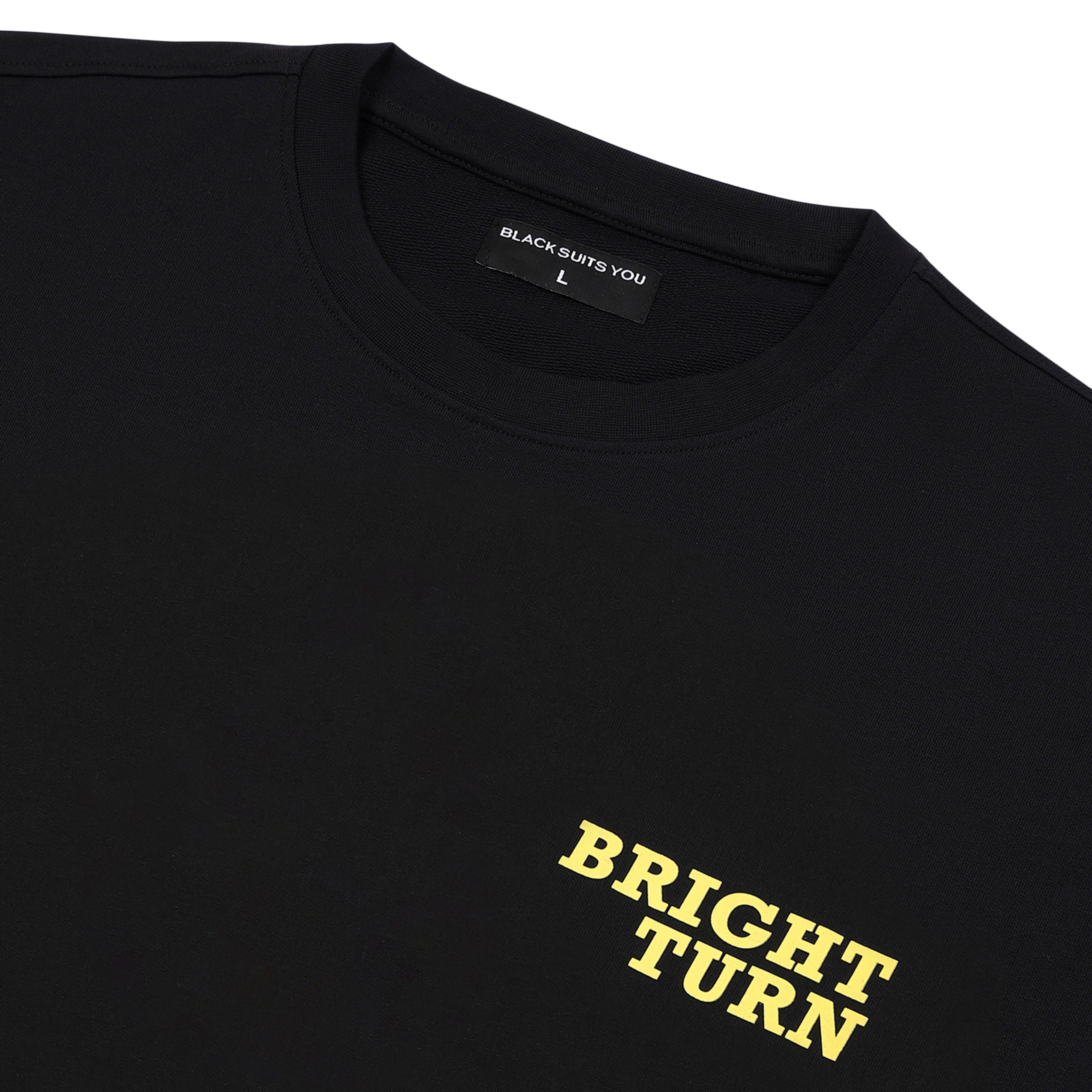 Black streetwear t-shirt with yellow 'BRIGHT TURN' text on chest and crew neck.
